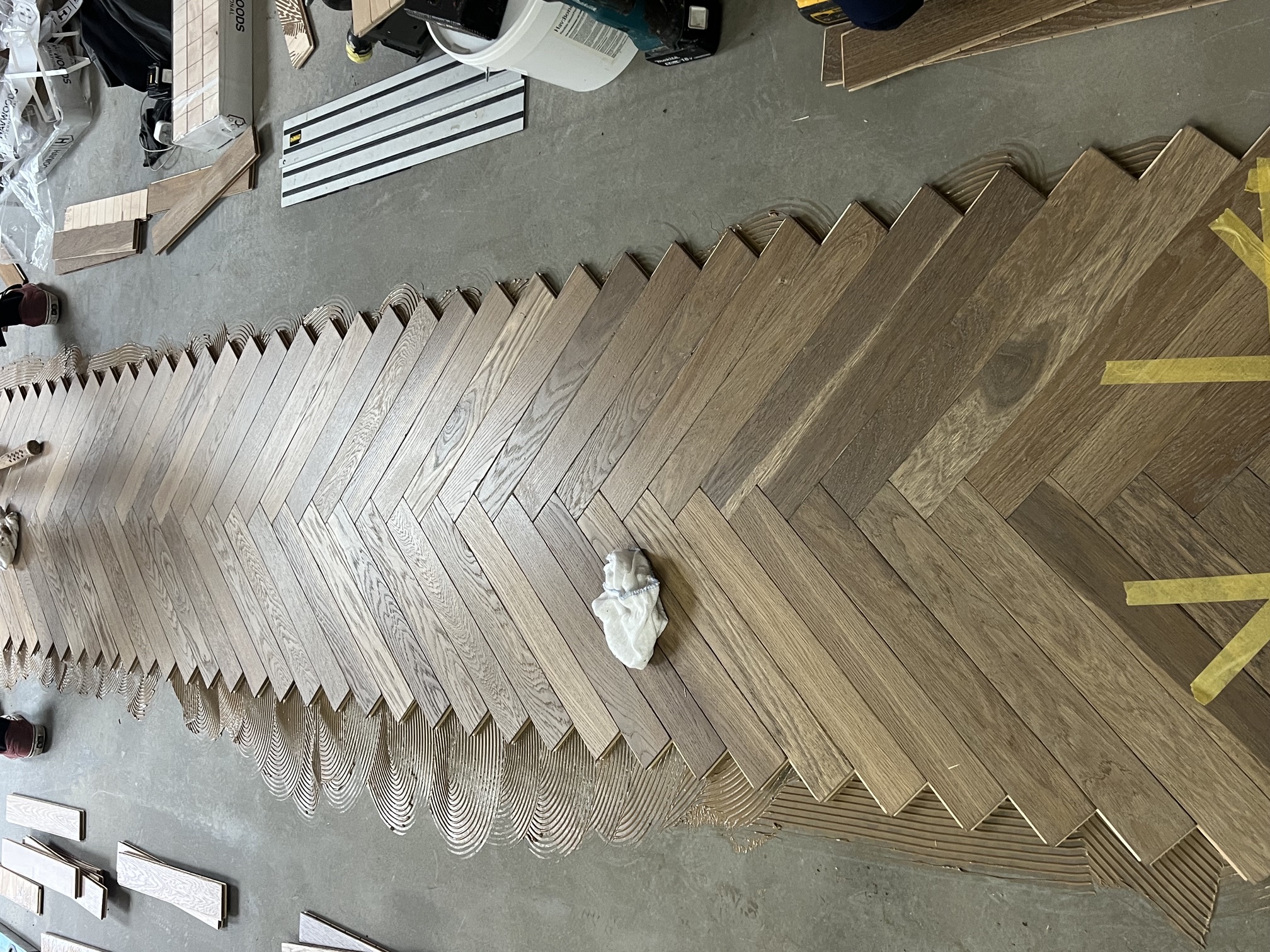 Engineered oak herringbone flooring being installed