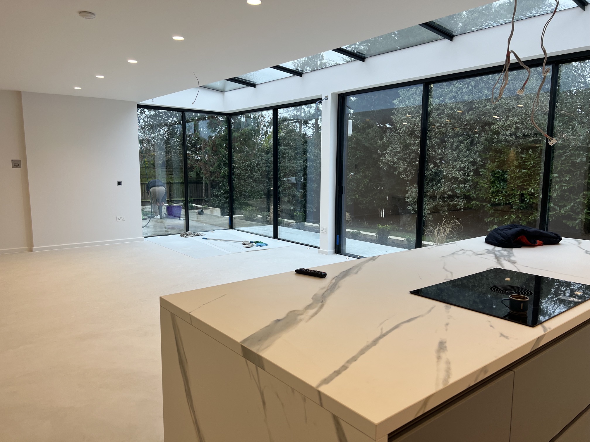 Open-plan kitchen with a glass box rear extension and bifold doors