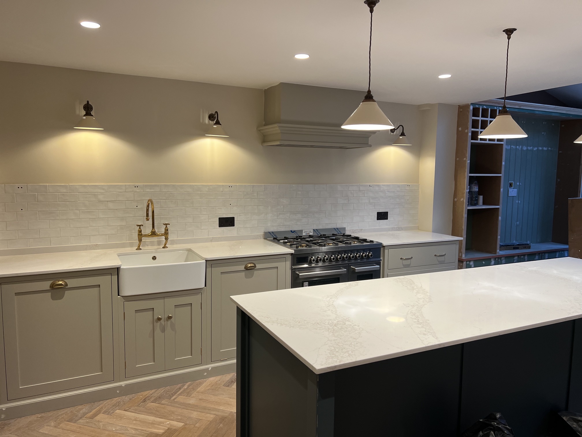 Classic shaker kitchen with Belfast sink, brass tap and metro tiles
