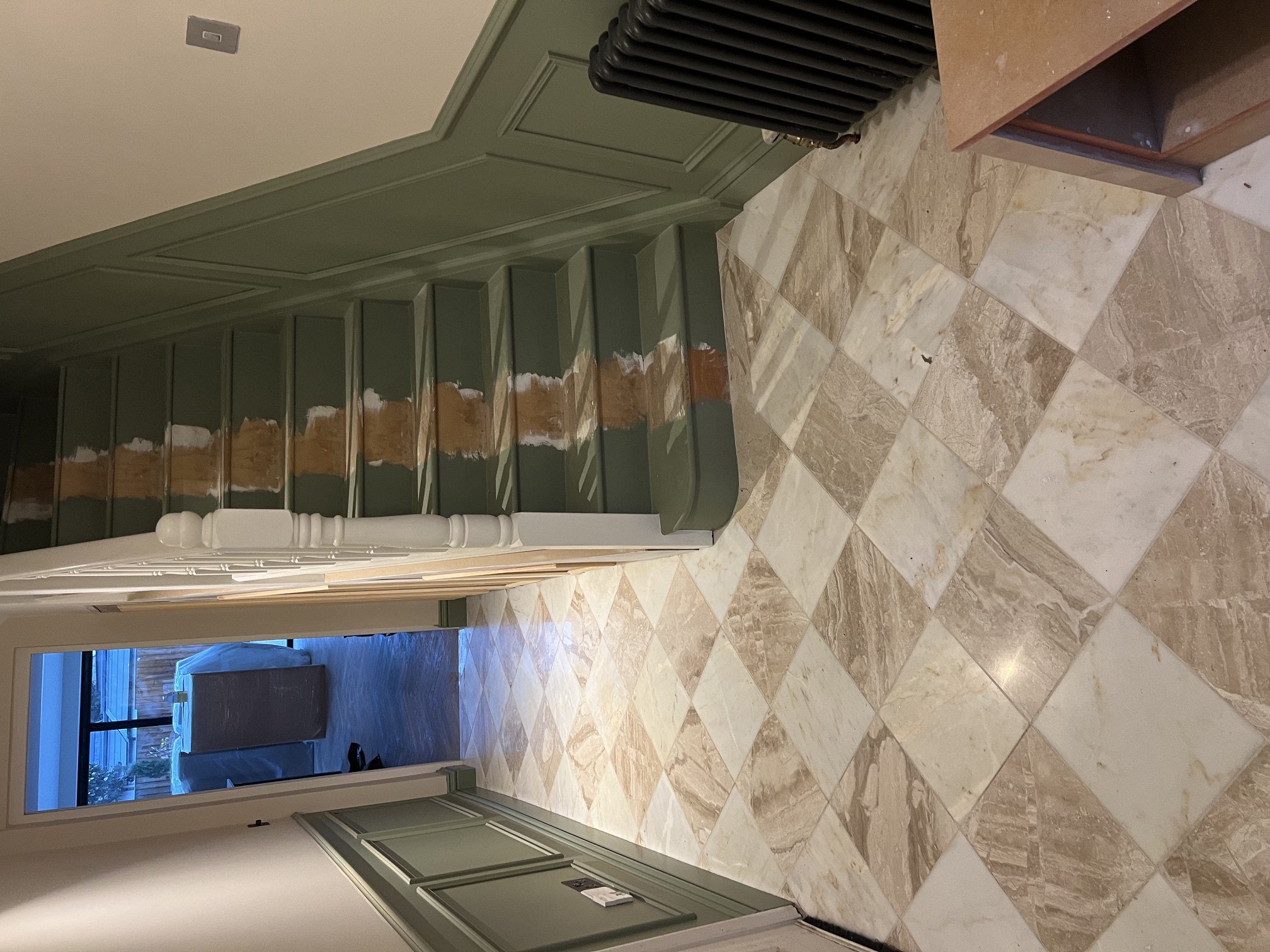 Marble checkerboard hallway floor with green panelled walls