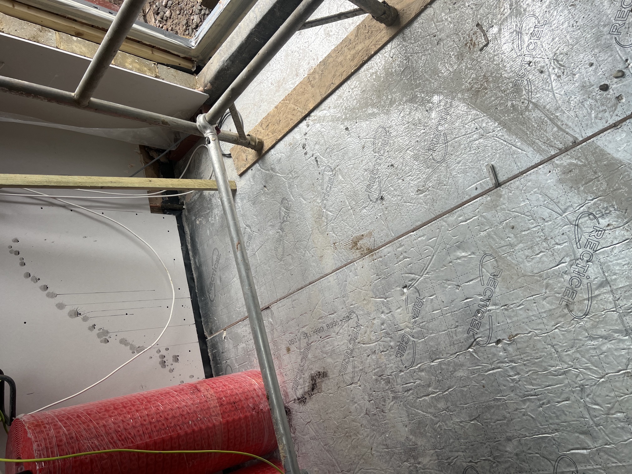 Underfloor heating pipes and insulation boards being laid